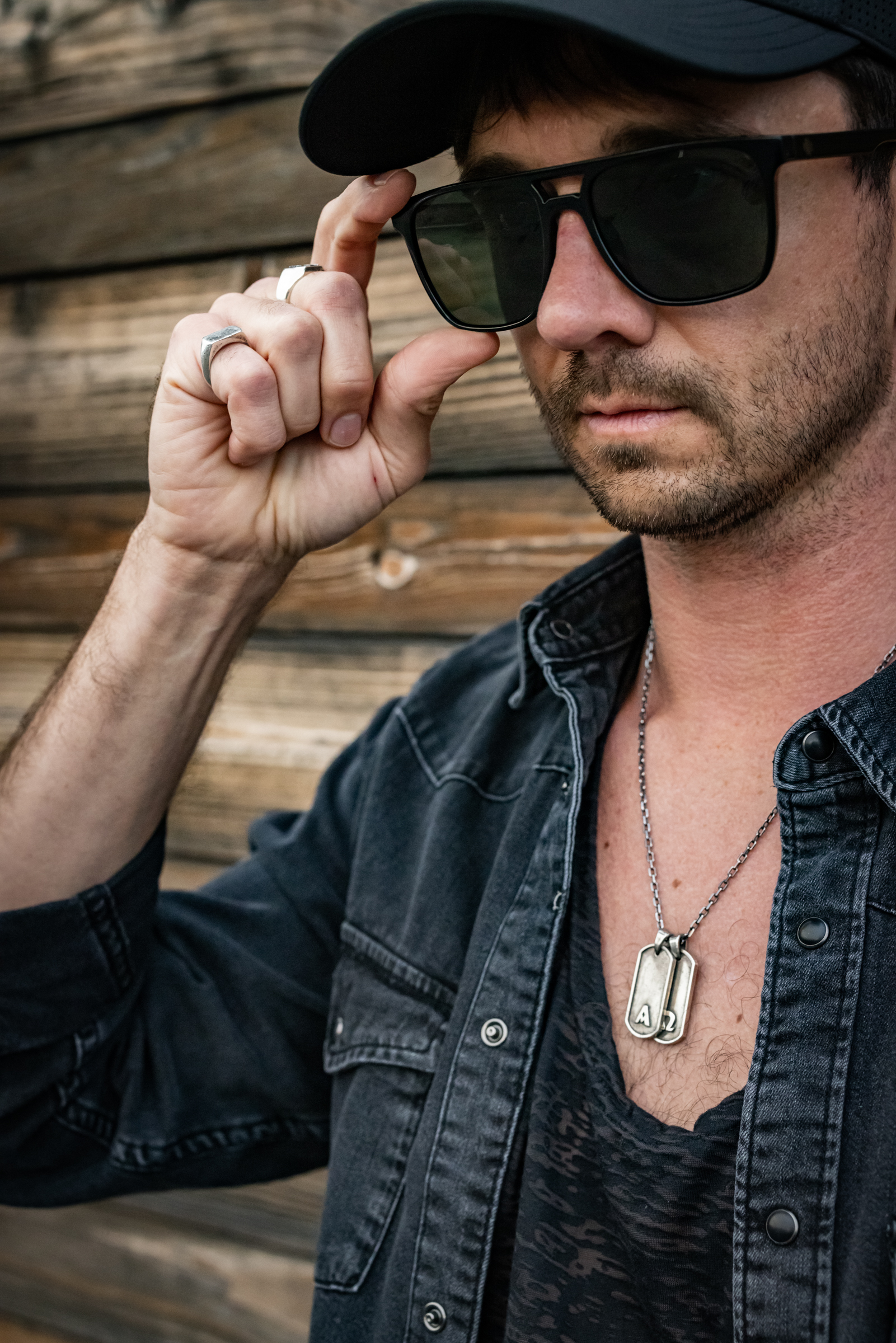Model showing Darma silver signet rings on both hands — men\u2019s accessories photography by Murrieta Media